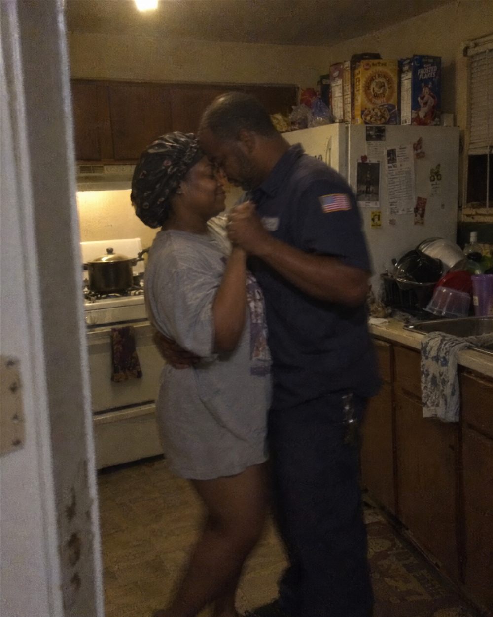 Couple slow dancing in their kitchen